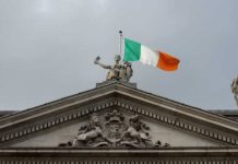 Irish regulator calls on lottery firms and others to register licence interest The Irish flag over a government building.