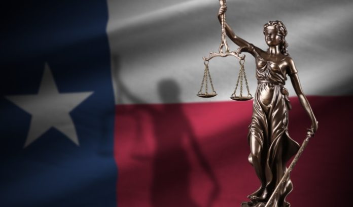 An imageo f the Texas flag with scales of justice