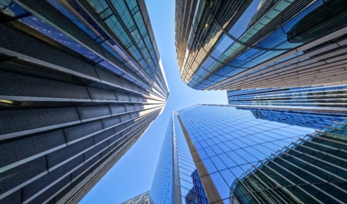 A POV looking up at the glass towers of London, where the new EveryMatrix HQ is located