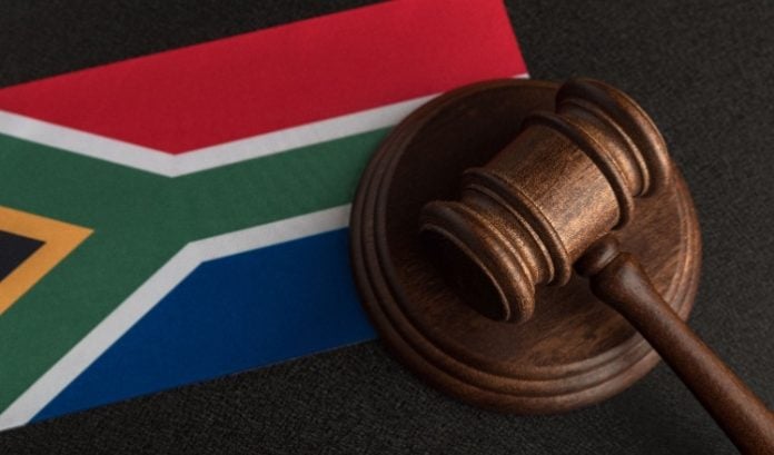 A court hammer laying on the flag of South Africa