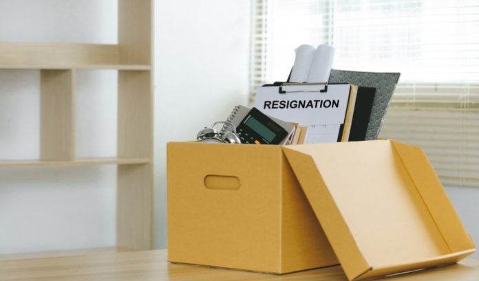An image of a packed box and resignation sign
