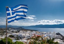 Greece lottery ripe for taking as Allwyn concession ends The Greek flag waving over a village
