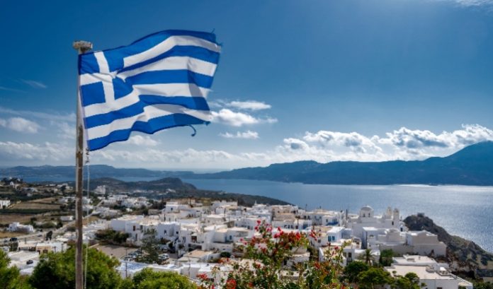 The Greek flag waving over a village