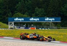 Allwyn has a social gaming future planned for the National Lottery UK National Lottery operator Allwyn branding at a Formula One event with McLaren car in foreground