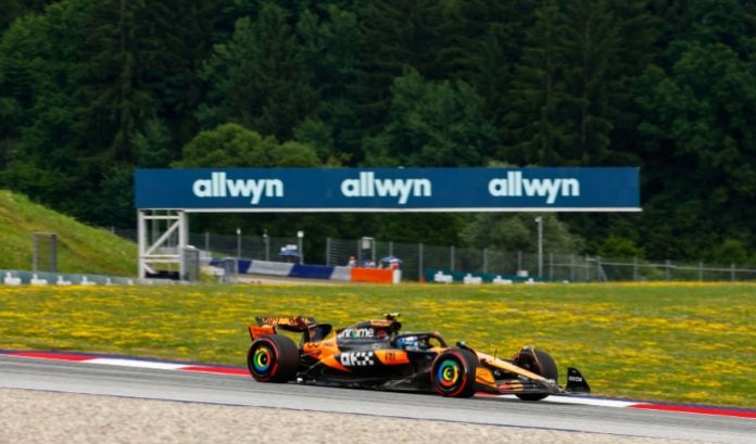 Allwyn branding at a Formula One event UK National Lottery operator Allwyn branding at a Formula One event with McLaren car in foreground