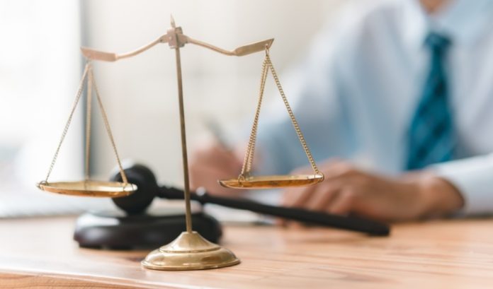 Scales-of-justice Scales of justice on a lawyer's desk, concept of legal challenge