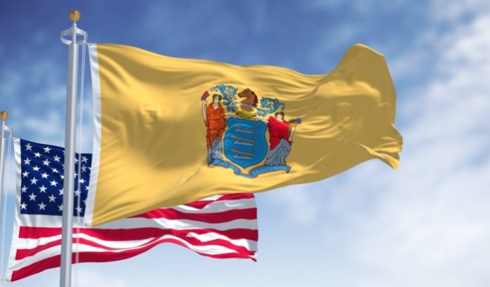 Flag of New Jersey flying in front of the flag of the US