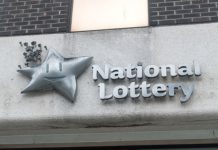 Irish researchers accuse National Lottery of downplaying gambling status Logo of the Irish National Lottery on a building