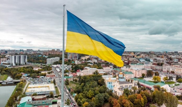 Ukraine-flag Flag of Ukraine flying over a city