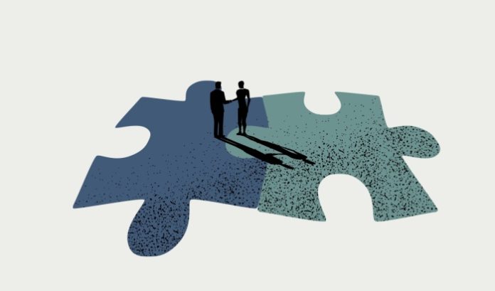 merger Puzzle pieces getting put together, symbolic of the merger between Allwyn and OPAP