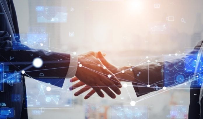 tech-handshake A handshake with a technology twist, symbolic of Random State's new deal