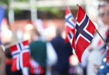 Postcode Lottery secures Norway renewal with expanded scope Norwegian flags lined up on a street