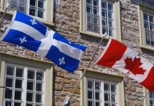 Loto-Québec hits back against calls for provincial online gambling market Flags of Quebec and Canada side by side