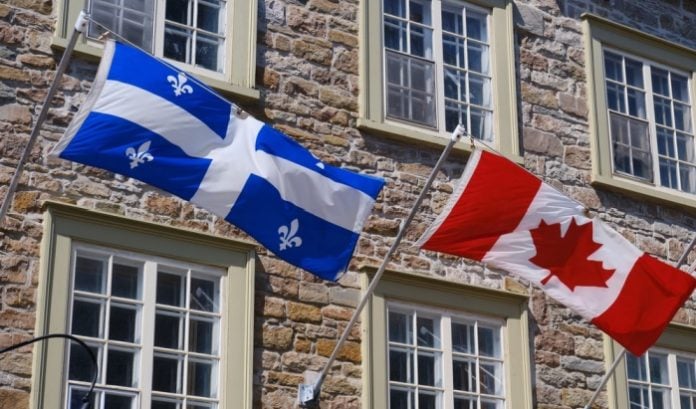 Quebec-and-Canada Flags of Quebec and Canada side by side