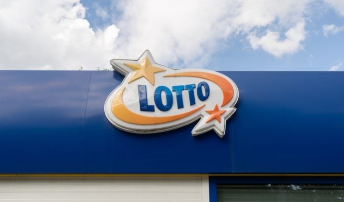 A sign for Poland's Totalizator Sportowy on the roof of a store