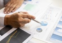 Pollard Banknote CFO Rob Rose to leave after 31-year tenure at listed firm A man looking over graphs and charts, symbolic of a Chief Financial Officer like Pollard's who has just stepped down