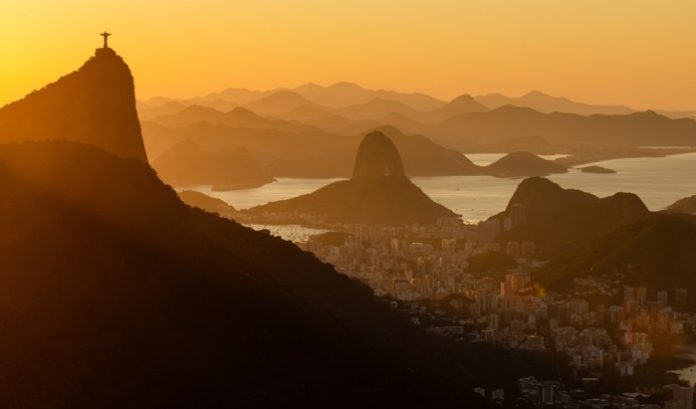 landscape of Rio de Janeiro, Brazil, during a sunset, with Christ the Redeemer above the city