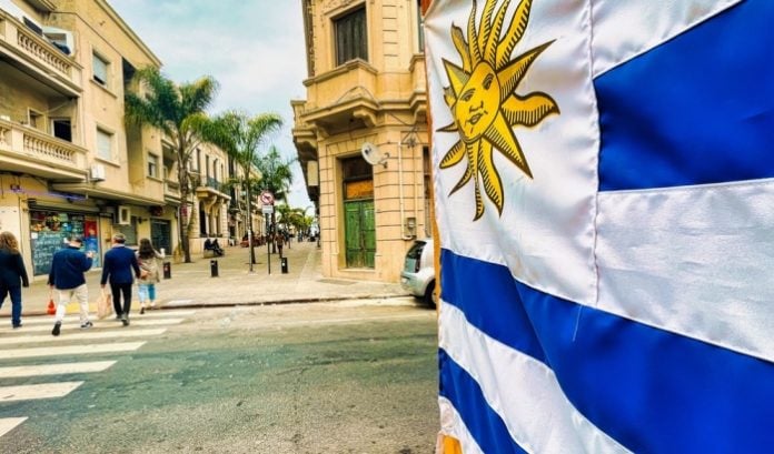Flag of Uruguay, where Scientific Games has signed its latest deal, on a city street