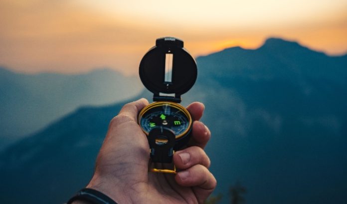 compass A hand holding a compass