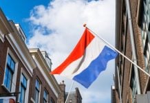 Dutch prize draw fined as gambling regulator asserts market control The Dutch flag hanging over a street