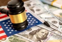 Lottery.com owner SEGG Media suing White Diamond short sellers for $20m A judges gavel on top of a US flag and dollars, symbolising SEGG"s lawsuit