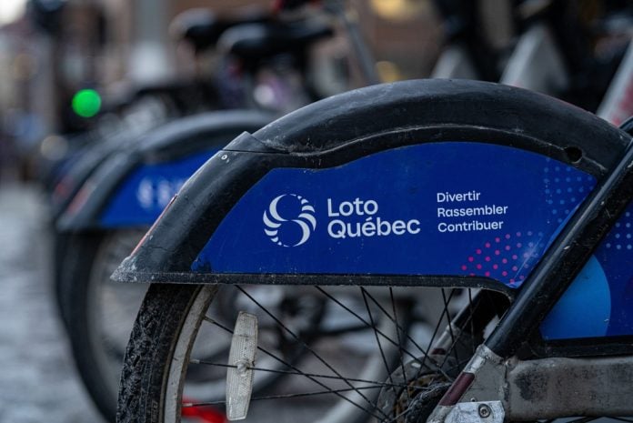 Close,Up,Of,Loto,Quebec,Logo,On,Public,Bicycle,Fender Loto-Québec logo on a bicycle