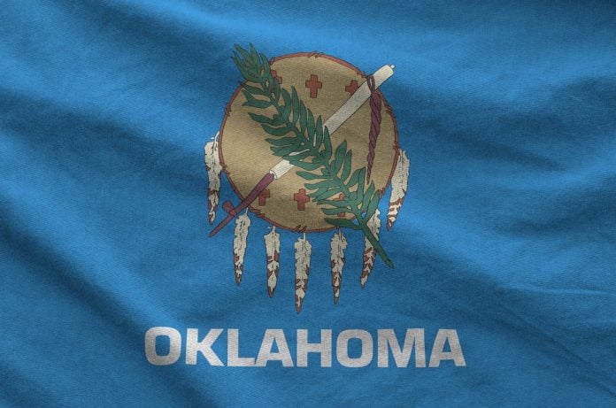 Oklahoma,Us,State,Flag,Depicted,On,Folded,Wavy,Fabric,Of Oklahoma flag